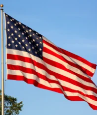 american flag flying on a pole.
