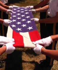 close shot of American flag in hands, they are folding the flag.